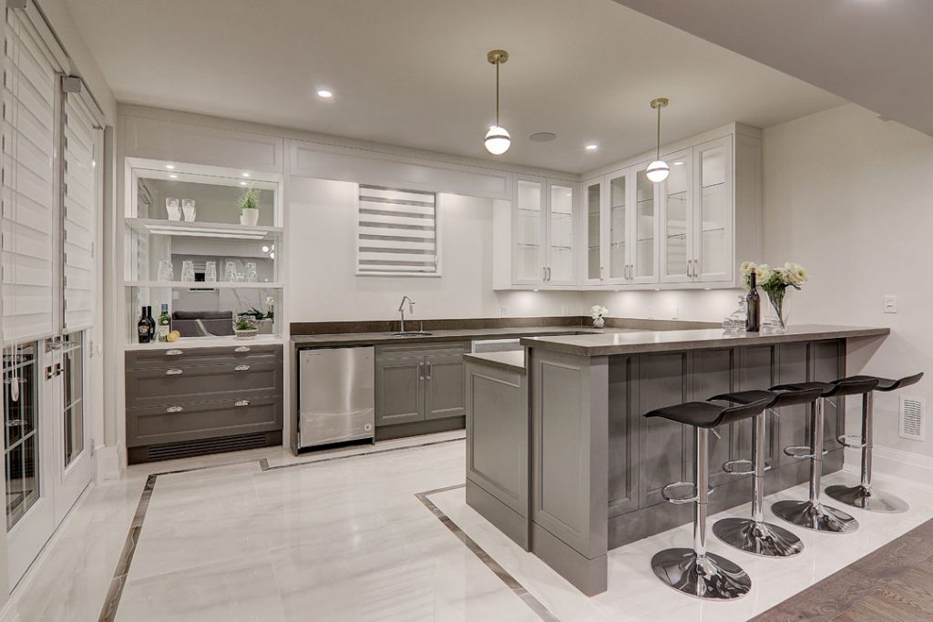 grey kitchen cabinets and white tiled flooring with island