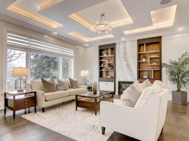 Living room with white modern sofas, cabinets, and brown coffee-table
