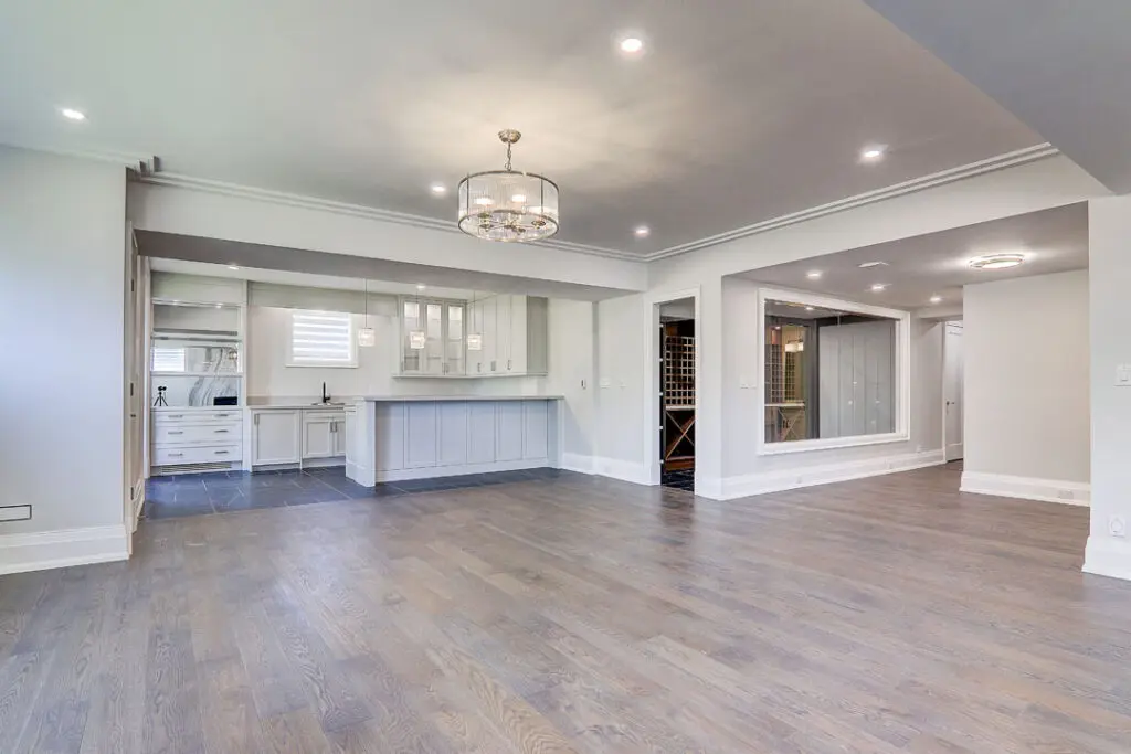 basement white kitchen with cabinets and island