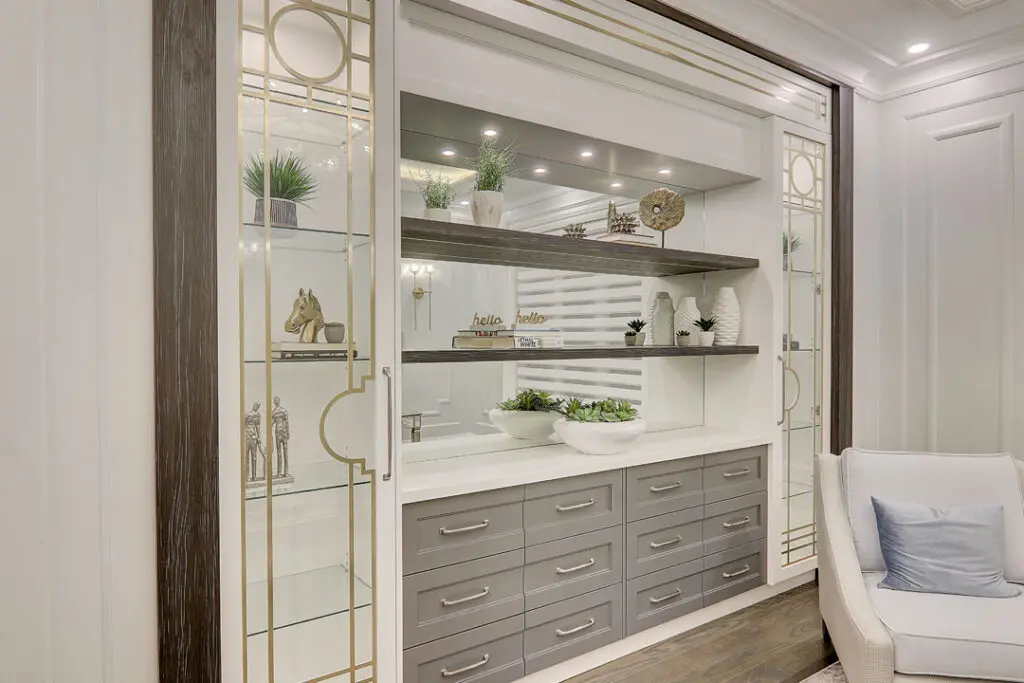 wall framed sliding drawers with floating shelves and glass door cabinets