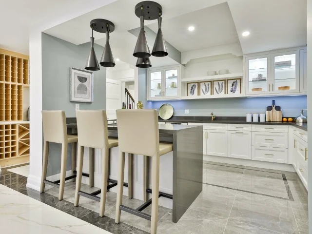 kitchen island with sitting chairs and custom cabinets