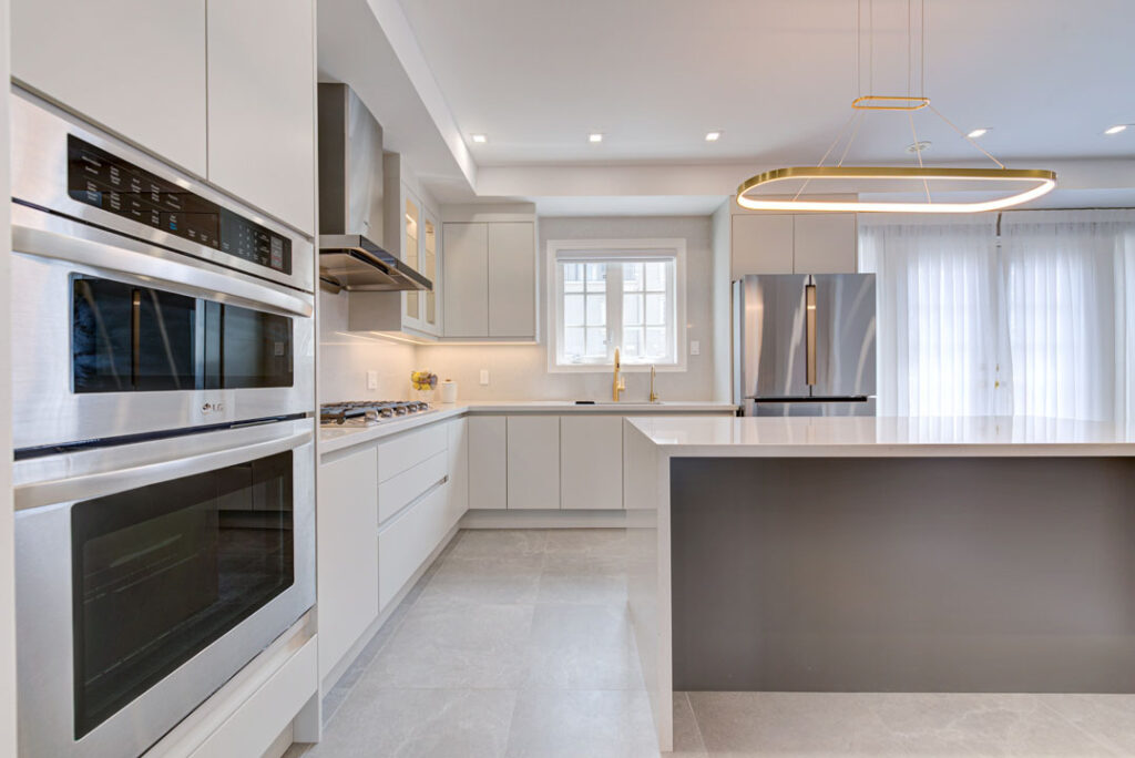 white and grey kitchen with island and white cabinets with white ceramic countertop