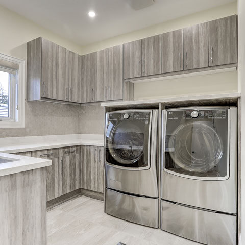 laundry room with custom cabinets